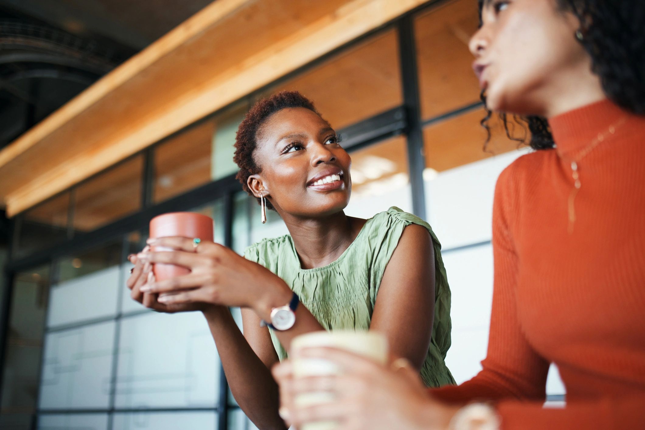 Two women in conversation over coffee